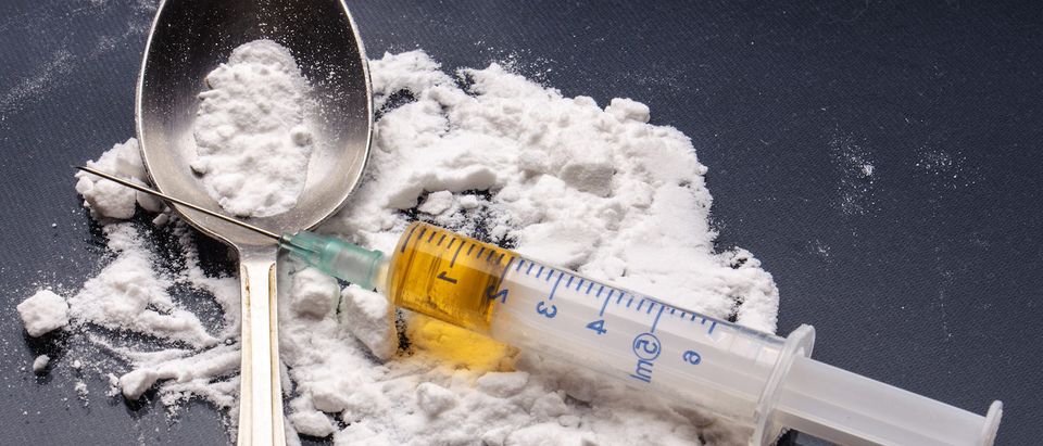A drug syringe and cooked heroin on spoon. (Shutterstock/Evdokimov Maxim)
