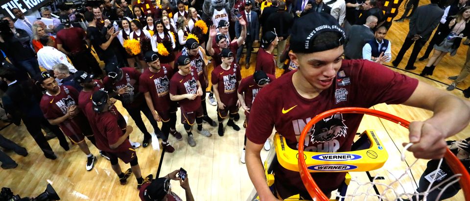 Lucas Williamson #1 of the Loyola Ramblers celebrates by cutting down the net after defeating the Kansas State Wildcats during the 2018 NCAA Men's Basketball Tournament South Regional at Philips Arena on March 24, 2018 in Atlanta. Loyola defeated Kansas State 78-62 to advance to the Final Four. (Photo by Ronald Martinez/Getty Images)