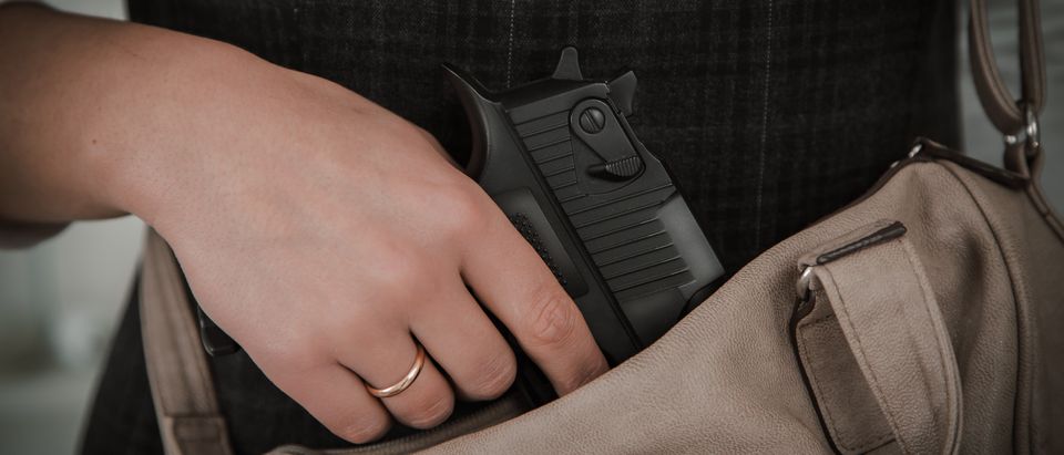 Woman with concealed carry (shutterstock)