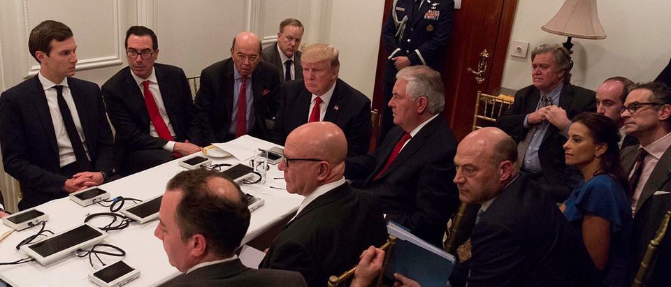 U.S. President Donald Trump is shown in an official White House handout image meeting with his National Security team and being briefed by Chairman of the Joint Chiefs of Staff General Joseph Dunford via secure video teleconference after a missile strike on Syria while inside the Sensitive Compartmented Information Facility at his Mar-a-Lago resort in West Palm Beach, Florida, U.S. April 6, 2017. White House Press Secretary Sean Spicer stated that this image has been digitally edited for security purposes when he released the photo via Twitter on April 7, 2017. Pictures clockwise from top L: Deputy Chief of Staff Joe Hagin, Senior Advisor Jared Kushner, Treasury Secretary Steven Mnuchin, Commerce Secretary Wilbur Ross, White House Press Secretary Sean Spicer, President Trump, Secretary of State Rex Tillerson, Senior advisor Steve Bannon, Senior advisor Stephen Miller, national security aide Michael Anton, Deputy National Security Advisor for Strategy Dina Powell, National Economic Council Director Gary Cohn, National security adviser Lt. Gen. H.R. McMaster and Chief of Staff Reince Priebus. The White House/Handout via REUTERS | Michael Anton To Resign