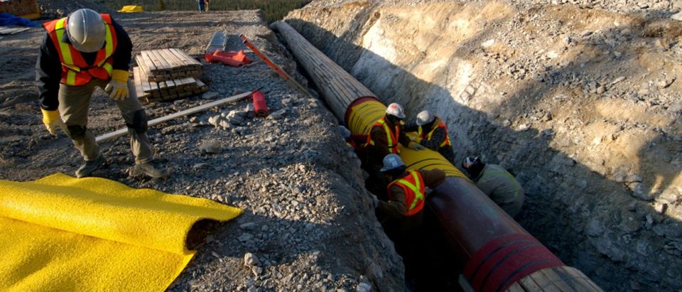 FILE PHOTO: Workers construct the Anchor Loop section of Kinder Morgan's Trans Mountain pipeline expansion in Jasper National Park in a 2009 file photo. Kinder Morgan Canada/Handout/File Photo via REUTERS | FERC Reviewing Pipeline Approval Process