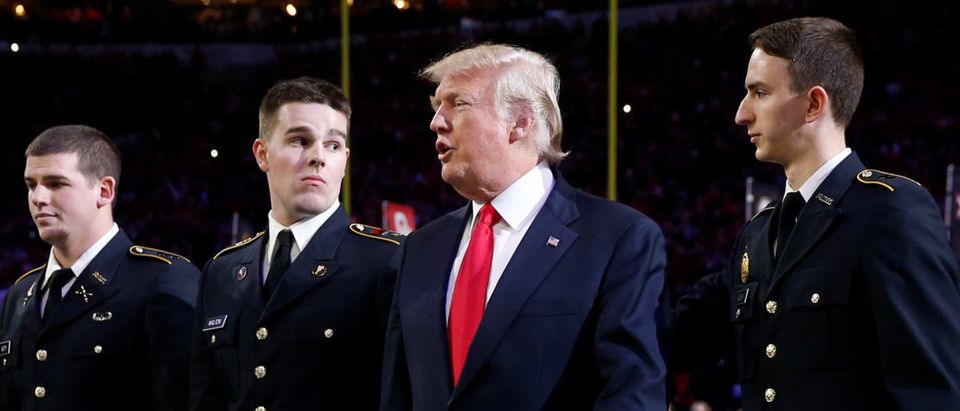 U.S. President Donald Trump arrives with ROTC students to participate in the national anthem before the NCAA College Football Playoff Championship game between Alabama and Georgia in Atlanta, Georgia, U.S. January 8, 2018. REUTERS/Jonathan Ernst