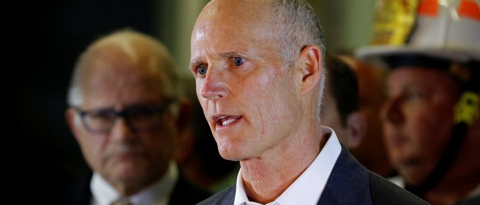 Florida Governor Rick Scott speaks to the media as rescue efforts continue after a pedestrian bridge collapsed at Florida International University in Miami