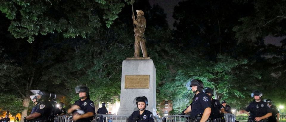 Police wearing riot gear guard a statue of a Confederate soldier nicknamed Silent Sam on the campus of the University of North Carolina during a demonstration for its removal in Chapel Hill, North Carolina, U.S. August 22, 2017. REUTERS/Jonathan Drake TPX IMAGES OF THE DAY | Confederate Memorials Under Attack