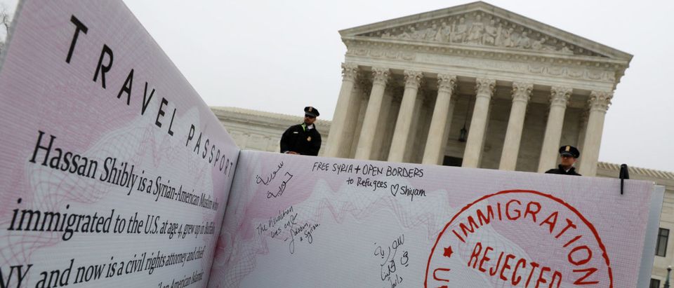 A mock-up of banned Muslim travellers' passport is placed outside the U.S. Supreme Court, while the court justices consider case regarding presidential powers as it weighs the legality of President Donald Trump's latest travel ban targeting people from Muslim-majority countries in Washington, DC, U.S., April 25, 2018. REUTERS/Yuri Gripas