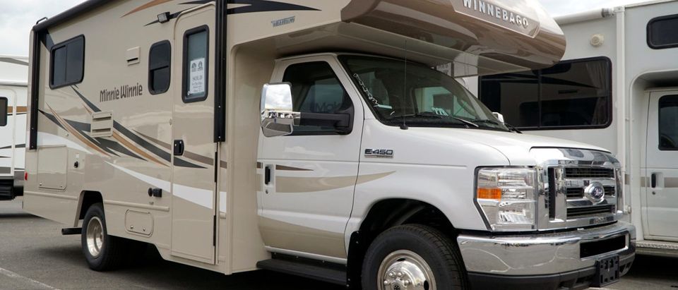 A pair of Winnebago motorhomes are ready for sale at a dealer in Golden