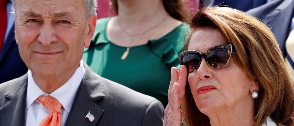 U.S. House Minority Leader Nancy Pelosi (D-CA) leads Democratic members of Congress, including Senate Minority Leader Chuck Schumer (D-NY) (L), during their "Better Deal" platform rally at the U.S. Capitol in Washington, May 21, 2018. REUTERS/Jonathan Ernst