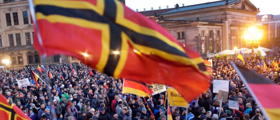 People gather for an anti-immigration demonstration organised by rightwing movement Patriotic Europeans Against the Islamisation of the West (PEGIDA) in front of the Palace Church in Dresden, Germany October 12, 2015. REUTERS/Hannibal Hanschke