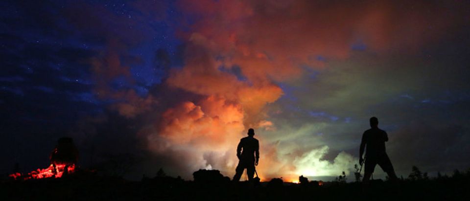 PAHOA, HI - MAY 15: Photographers work as lava from active fissures illuminates volcanic gases from the Kilauea volcano on Hawaii's Big Island on May 15, 2018 in Hawaii Volcanoes National Park, Hawaii. The U.S. Geological Survey said a recent lowering of the lava lake at the volcano's Halemaumau crater Òhas raised the potential for explosive eruptionsÓ at the volcano. (Photo by Mario Tama/Getty Images) | Volcano Spurts Ash 30,000 Feet In Sky
