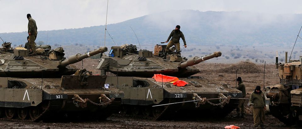 Israeli soldiers stand atop tanks in the Israeli-occupied Golan Heights, close to Israel's frontier with Syria November 22, 2017. REUTERS/Ammar Awad