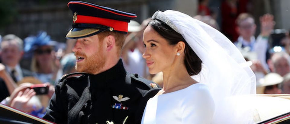 WINDSOR, ENGLAND - MAY 19: Prince Harry, Duke of Sussex and The Duchess of Sussex leave Windsor Castle in the Ascot Landau carriage during a procession after getting married at St Georges Chapel on May 19, 2018 in Windsor, England. Prince Henry Charles Albert David of Wales marries Ms. Meghan Markle in a service at St George's Chapel inside the grounds of Windsor Castle. Among the guests were 2200 members of the public, the royal family and Ms. Markle's Mother Doria Ragland. (Photo by Gareth Fuller - WPA/Getty Images)