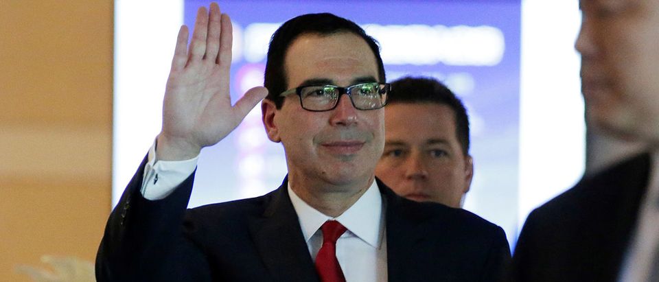 U.S. Treasury Secretary Steven Mnuchin waves to the media as he and the U.S. delegation for trade talks with China, leave a hotel in Beijing