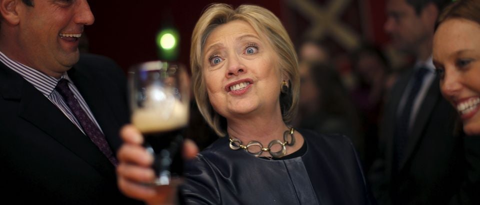 Democratic U.S. Presidential candidate Hillary Clinton cheers as she drinks a beer at a local bar during a campaign stop in Youngstown, Ohio