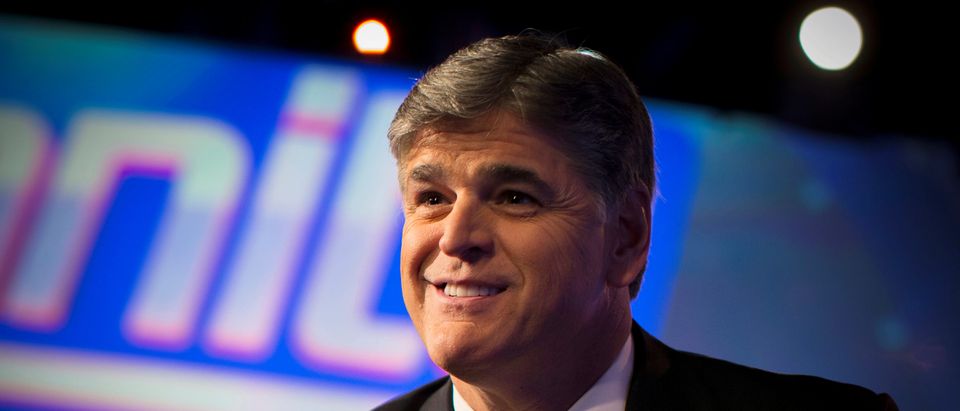FILE PHOTO - Fox News Channel anchor Sean Hannity poses for photographs as he sits on the set of his show "Hannity" at the Fox News Channel's headquarters in New York City