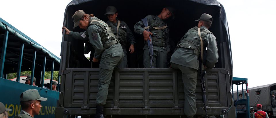 Soldiers standing practice before a ceremony to kick off the distribution of security forcers and voting materials to be used in the upcoming presidential elections, at Fort Tiuna military base in Caracas