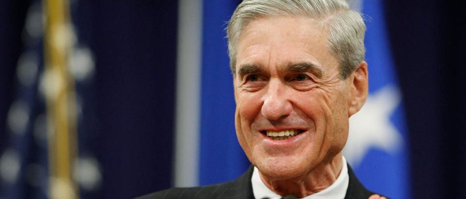 Mueller applauds key staff members during a farewell ceremony held for him at the Justice Department in Washington