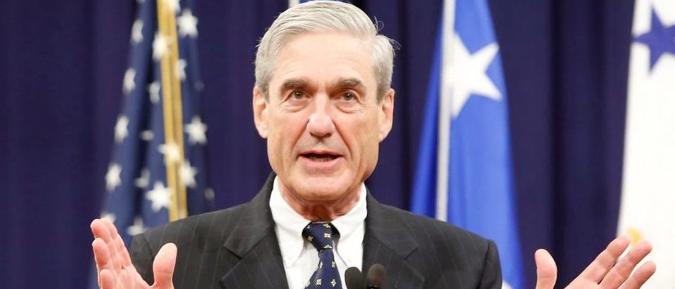 FILE PHOTO - Robert Mueller reacts to applause from the audience during his farewell ceremony at the Justice Department in Washington