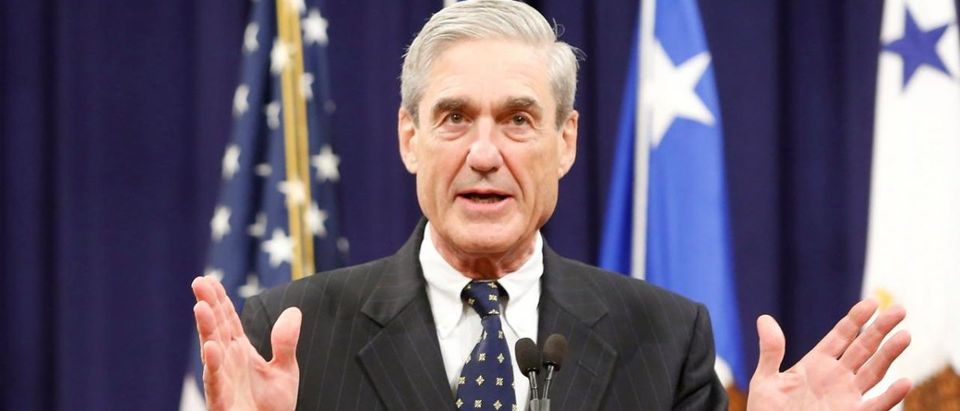 FILE PHOTO - Robert Mueller reacts to applause from the audience during his farewell ceremony at the Justice Department in Washington