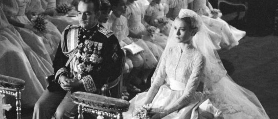 Prince Rainier of Monaco and American actress Grace Kelly (1929 - 1982) sit before the altar during their wedding ceremony at the Cathedral of Saint Nicholas, Monte Carlo, Monaco, April 19, 1956. Kelly's gown was designed by costume designer Helen Rose. (Photo by Thomas McAvoy/The LIFE Picture Collection/Getty Images)