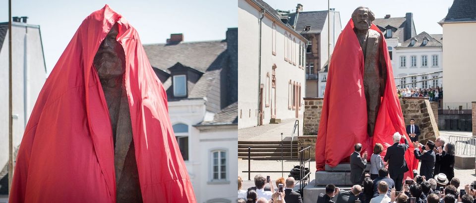 The sculpture of German philosopher and revolutionary Karl Marx is uncovered during its inauguration at the 200th anniversary of the birth of Karl Marx on May 5, 2018 in Trier, Germany. The bronze statue, by Chinese artist Wu Weishan, is weighing 2,3 tons and measures 4,40 meters. It is a present of the People's Republic of China. (Photos: Thomas Lohnes/Getty Images)