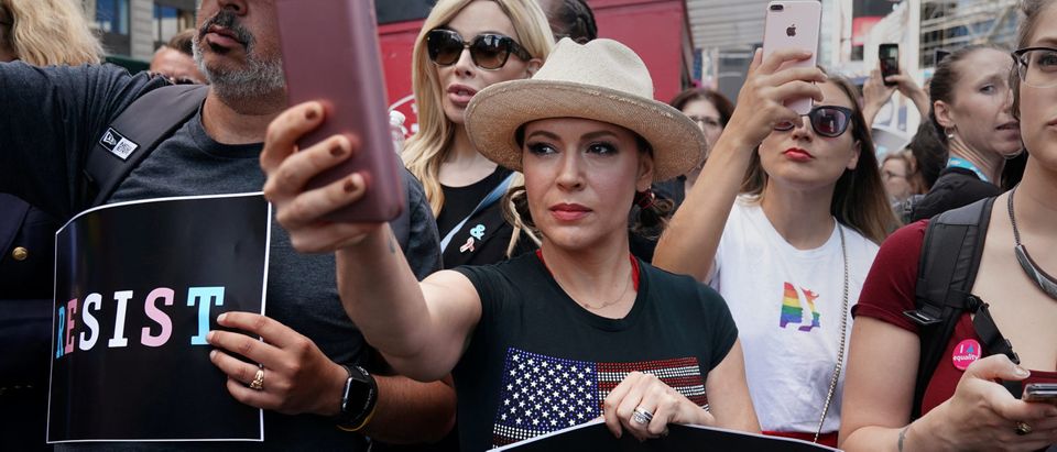 Actress Alyssa Milano attends a protest against U.S. President Donald Trump's announcement that he plans to reinstate a ban on transgender individuals from serving in any capacity in the U.S. military, in Times Square, in New York City, New York, U.S., July 26, 2017. REUTERS/Carlo Allegri