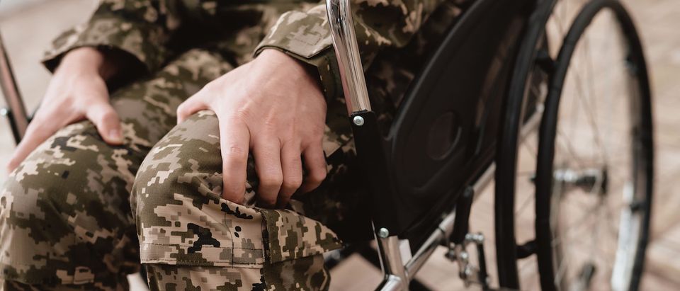 Veteran in wheelchair returned from army. Close-up photo veteran in a wheelchair. Wheelchairs and legs in military uniform. (Shutterstock/VGstockstudio) | Jim Smith Federal Vet Contracts Faulted
