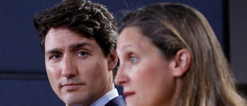 Canada's PM Trudeau listens to Foreign Minister Freeland during news conference in Ottawa