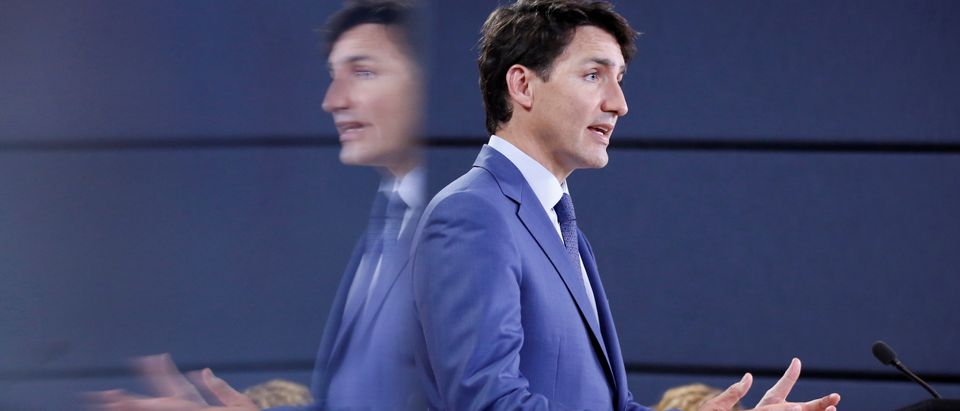 Canada's PM Trudeau is reflected in a monitor while speaking during a news conference in Ottawa