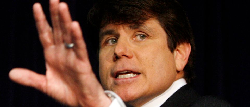 Governor Blagojevich of Illinois waves to the media after he addressed questions in Chicago