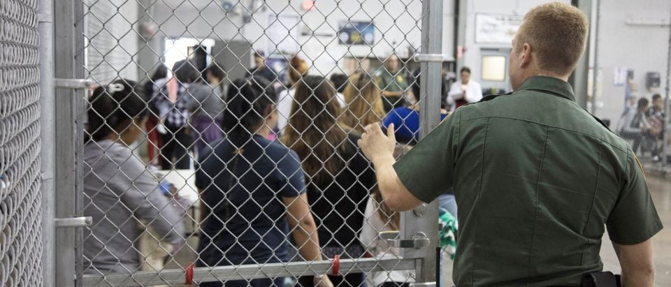 A view of inside CBP detention facility shows detainees inside fenced areas at Rio Grande Valley Centralized Processing Center in Texas