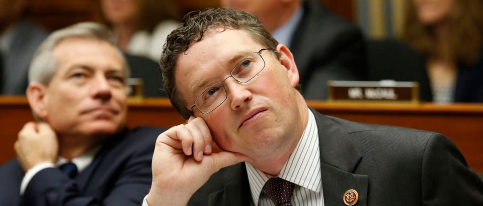 Representative Thomas Massie (R-KY) watches a live downlink with American astronauts aboard the International Space Station (ISS) Navy Commander G. Reid Wiseman (L) and Steven Swanson at the House Science, Space, and Technology Committee on Capitol Hill in Washington, July 24, 2014. REUTERS/Yuri Gripas
