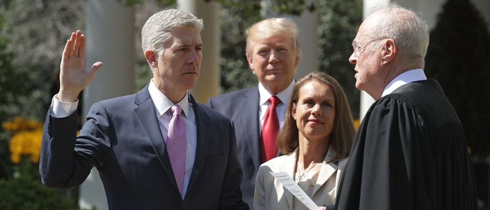 WASHINGTON, DC - APRIL 10: U.S. Supreme Court Associate Justice Anthony Kennedy (R) administers the judicial oath to Judge Neil Gorsuch as his wife Marie Louise Gorsuch holds a bible and President Donald Trump looks on during a ceremony in the Rose Garden at the White House April 10, 2017 in Washington, DC. Earlier in the day Gorsuch, 49, was sworn in as the 113th Associate Justice in a private ceremony at the Supreme Court. (Photo by Chip Somodevilla/Getty Images)