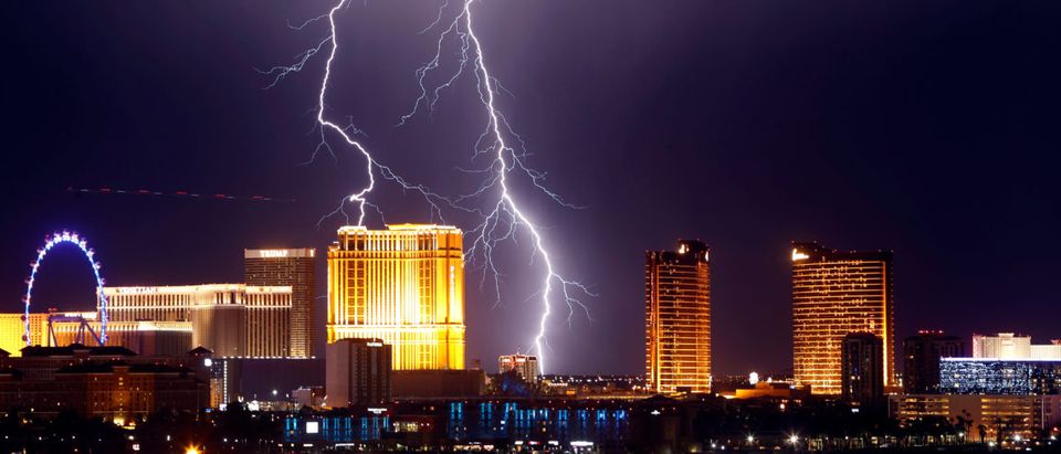 Lightning strikes behind Las Vegas Strip casinos as a thunderstorm passes through Las Vegas