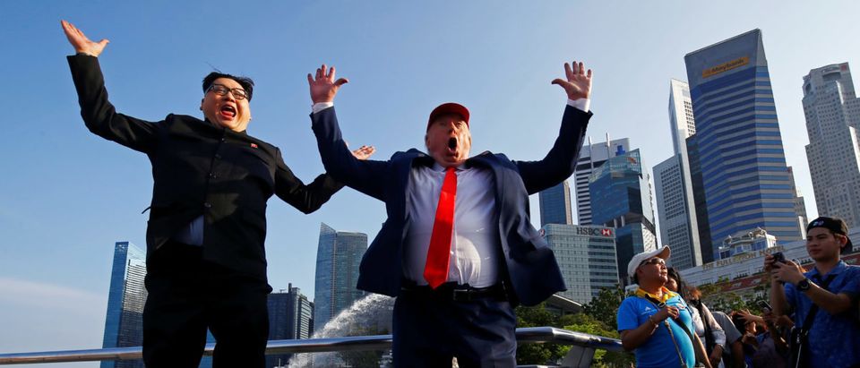 Howard, an Australian-Chinese impersonating North Korean leader Kim Jong-un, and Dennis Alan, impersonating U.S. President Donald Trump, meet at Merlion Park in Singapore June 8, 2018. REUTERS/Edgar Su