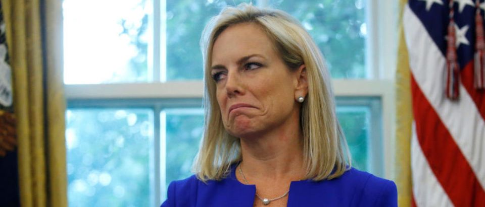 U.S. Department of Homeland Security (DHS) Secretary Kirstjen Nielsen holds an executive order on immigration policy, which was signed by U.S. President Donald Trump in the Oval Office at the White House in Washington, U.S., June 20, 2018. REUTERS/Leah Millis