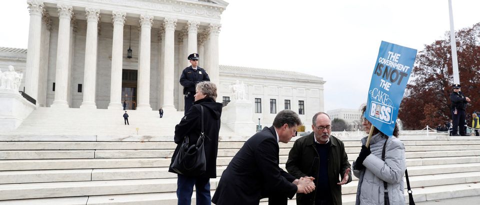 Demonstrators pray during oral arguments in the Masterpiece Cakeshop vs. Colorado Civil Rights Commission case at the Supreme Court in Washington, U.S., December 5, 2017. REUTERS/Aaron P. Bernstein