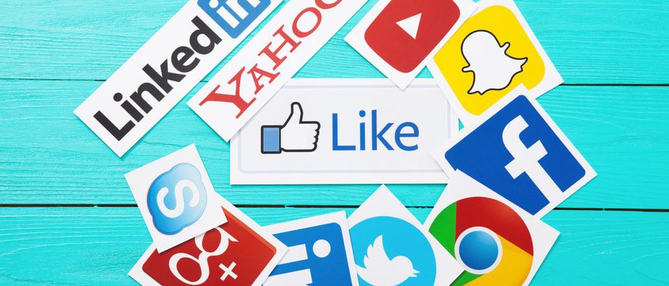 Collection of popular social media logos printed on paper: YouTube,Facebook, Twitter, Google Plus, Yahoo, Linkedin, Snapchat, Chrome and like on blue wooden background.(Image: Shutterstock.com)