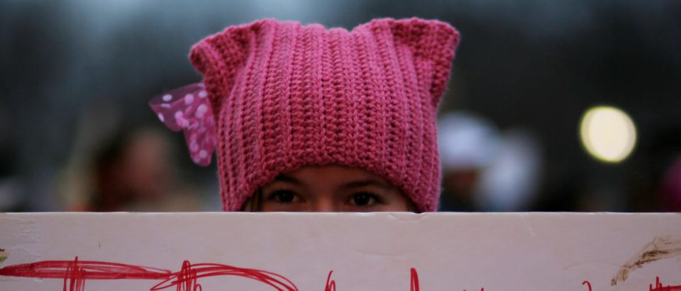 A woman wearing pink pussy protest hat poses for a photograph during the Women's March on Washington, following the inauguration of U.S. President Donald Trump, in Washington, DC, U.S. January 21, 2017. REUTERS/Brian Snyder
