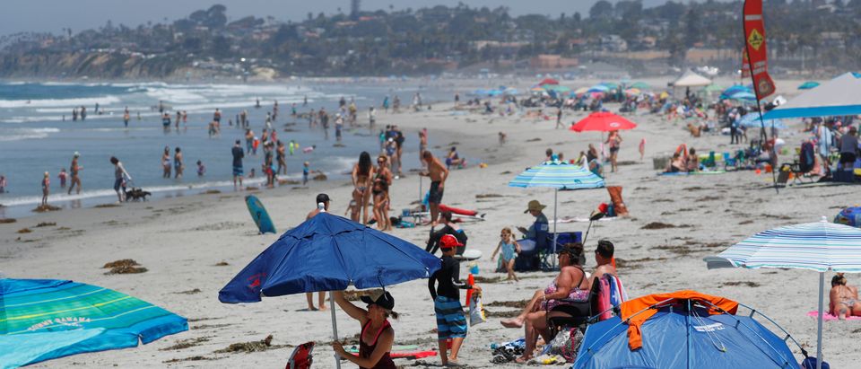 People cool off from a Southern California heat wave at Cardiff State beach in Encinitas, California