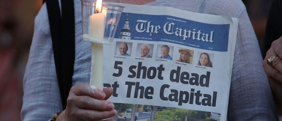 ANNAPOLIS, MD - JUNE 29: A women holds today's edition of the Capital Gazette newpaper during a candlelight vigil to honor the 5 people who were shot and killed yesterday, on June 29, 2018 in Annapolis, Maryland. Jarrod Ramos of Laurel Md. Has been arrested and charged with killing 5 people at the daily newspaper. (Photo by Mark Wilson/Getty Images)