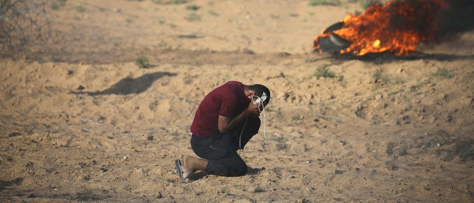 A Palestinian reacts to tear gas fired by Israeli troops during a protest at the Israel-Gaza border in the southern Gaza Strip July 13, 2018. REUTERS/Ibraheem Abu Mustafa