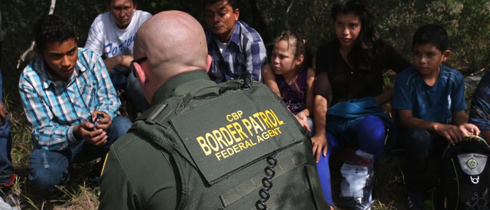 ROMA, TX - APRIL 14: A Border Patrol agent speaks with Central American immigrant families who crossed into the United States seeking asylum on April 14, 2016 in Roma, Texas. Border security and immigration, both legal and otherwise, continue to be contentious national issues in the 2016 Presidential campaign. (Photo by John Moore/Getty Images)