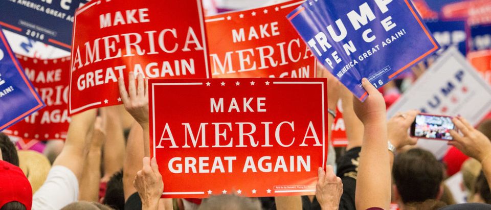 Manheim, PA - October 1, 2016: People enthusiastically wave Make America Great Again Signs at a Donald Trump campaign rally.