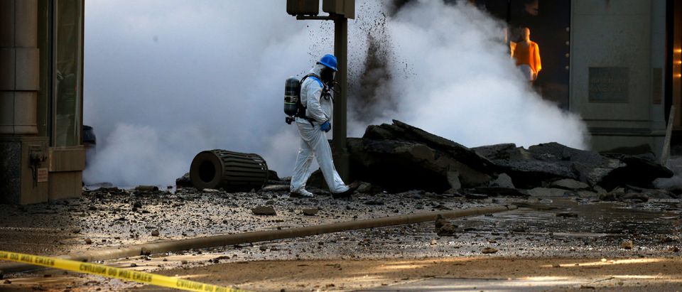 An Emergency Responder examines Midtown Manhattan's steam pipe explosion in New York City