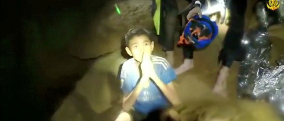 Boys from the under-16 soccer team trapped inside Tham Luang cave greet members of the Thai rescue team in Chiang Rai, Thailand, in this still image taken from a July 3, 2018 video by Thai Navy Seal. Thai Navy Seal/Handout via REUTERS