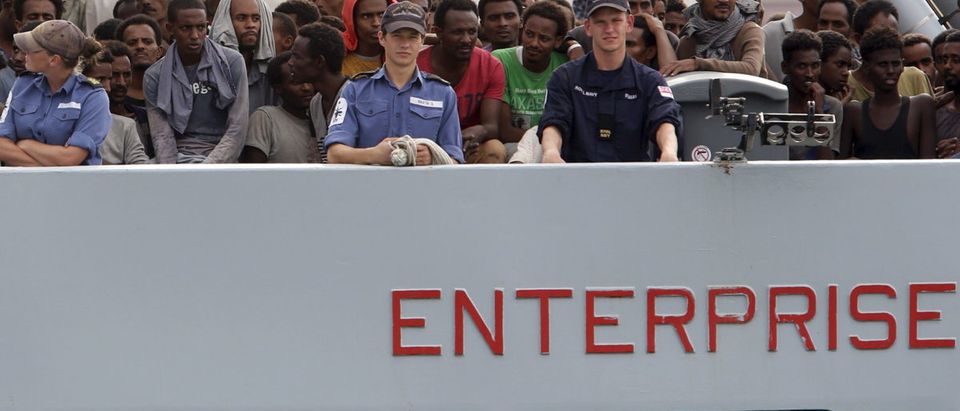 Migrants arrive on the British vessel HMS Enterprise before disembarking in the Sicilian harbour of Catania, Italy, October 6, 2015. REUTERS/Antonio Parrinello