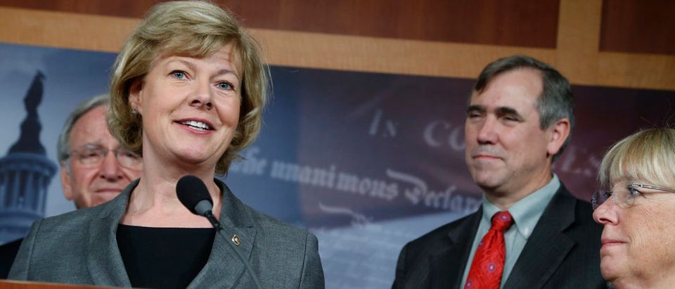 U.S. Senator Tammy Baldwin (From 2nd L-R), Senator Jeff Merkley and Senator Patty Murray appear at a news conference to celebrate overcoming the last procedural hurdle to bring a vote in the U.S. Senate on legislation to ban workplace discrimination against gay individuals at the U.S. Capitol in Washington, November 7, 2013. Also pictured is Senator Tom Harkin (L). REUTERS/Jonathan Ernst