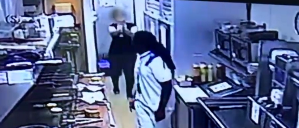 Restaurant footage of armed employee driving away suspect (screengrab)