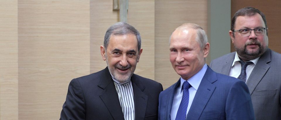 Russian President Putin shakes hands with top advisor to Iran's Supreme Leader Khamenei, Velayati during their meeting at the Novo-Ogaryovo state residence outside Moscow