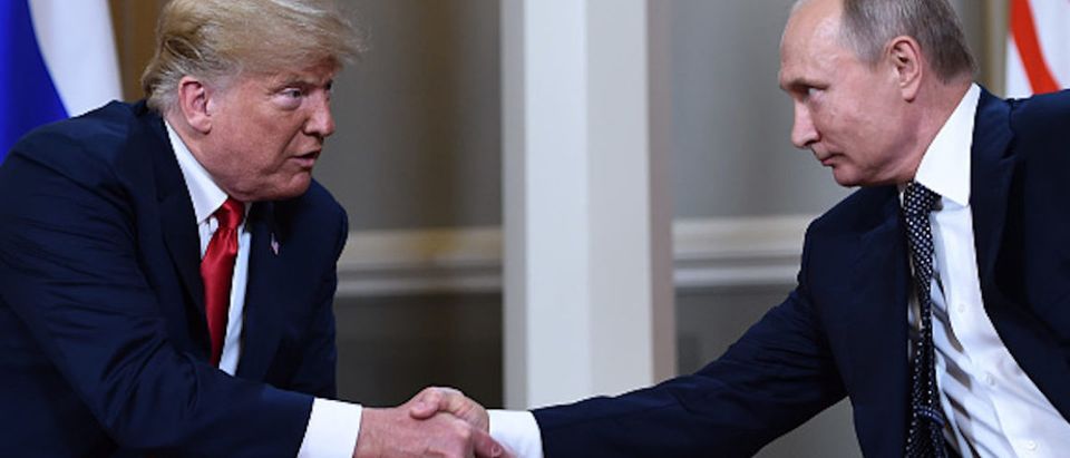 Russian President Vladimir Putin (R) and US President Donald Trump shake hands before a meeting in Helsinki, on July 16, 2018. (Photo: BRENDAN SMIALOWSKI/AFP/Getty Images)